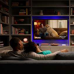 couple watching tv in library