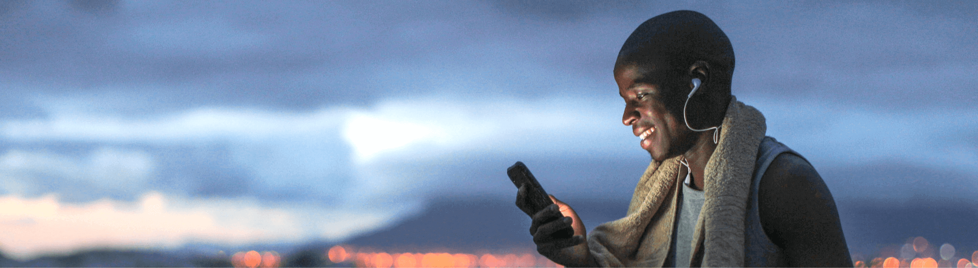 Man choosing music before going on a run at dawn