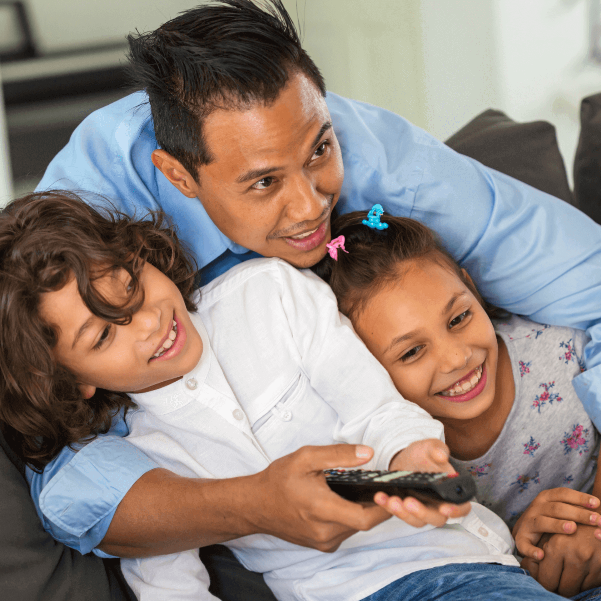 Family on couch with remote