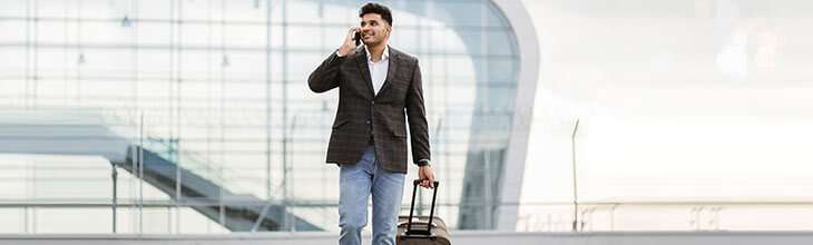 Man uses mobile phone while traveling