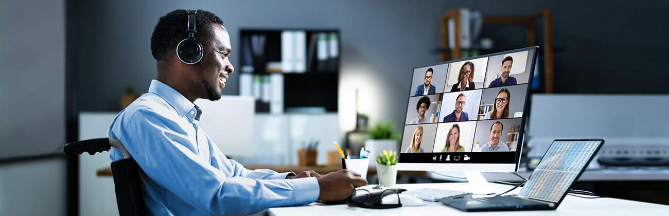 Professional man using a wheelchair video conferences from home.